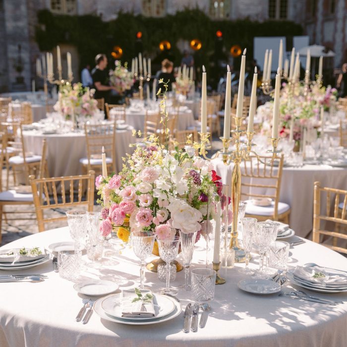 Elegant French château wedding dinner decor with candles and flowers